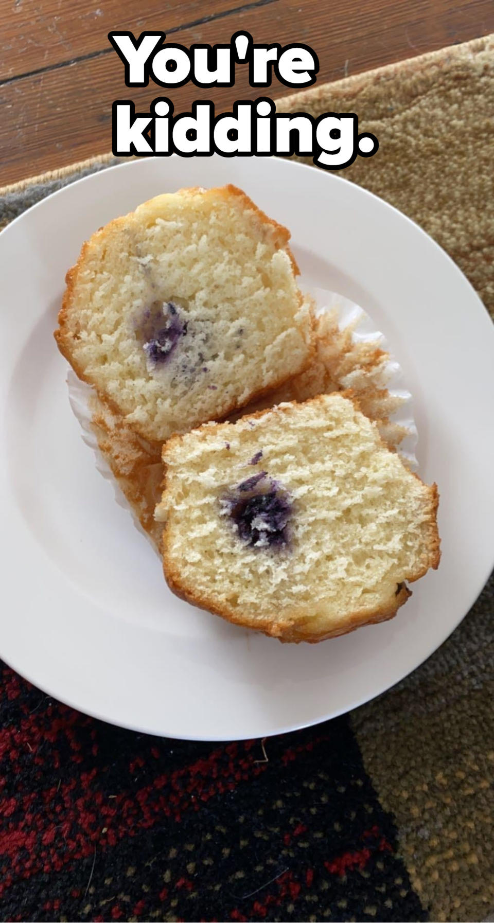 A cut muffin with one small blue stain in the middle