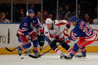 NEW YORK, NY - MAY 12: Alexander Semin #28 of the Washington Capitals attempts to control the puck against Derek Stepan #21 and Chris Kreider #20 of the New York Rangers in Game Seven of the Eastern Conference Semifinals during the 2012 NHL Stanley Cup Playoffs at Madison Square Garden on May 12, 2012 in New York City. (Photo by Paul Bereswill/Getty Images)