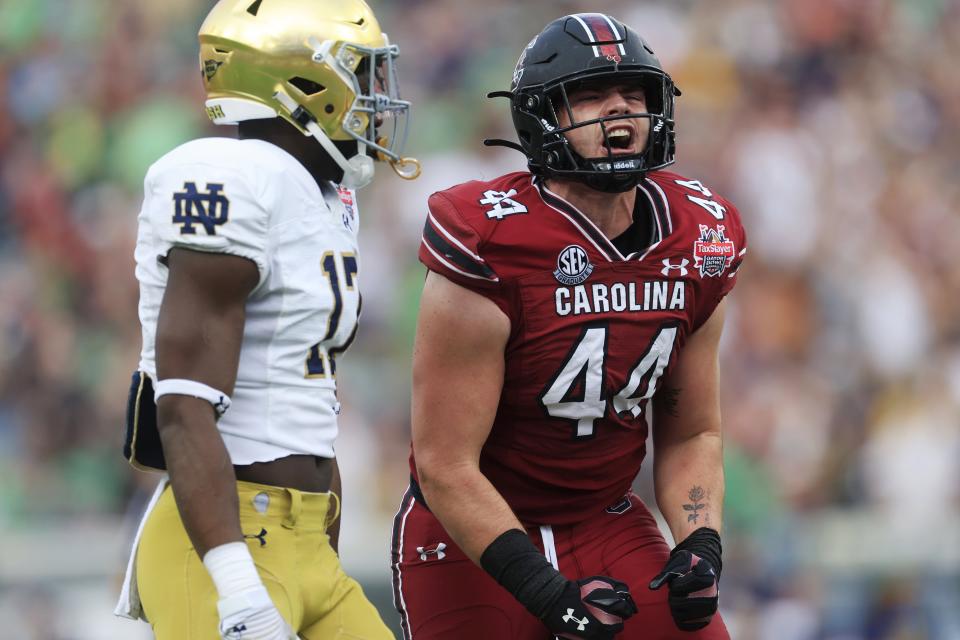 South Carolina Gamecocks tight end Nate Adkins (44) reacts to his run as Notre Dame Fighting Irish linebacker Jaylen Sneed (17) looks on during the first quarter of the TaxSlayer Gator Bowl of an NCAA college football game Friday, Dec. 30, 2022 at TIAA Bank Field in Jacksonville. [Corey Perrine/Florida Times-Union]