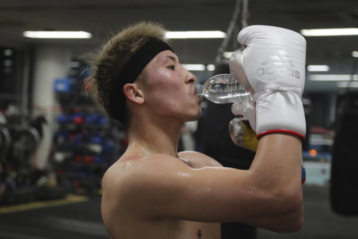Japanese boxer and the WBA and IBF bantamweight world champion Naoya Inoue drinks a bottle of water during a training at the Ohashi Boxing Gym in Yokohama, near Tokyo Nov. 23, 2021. Drawing praise as one of the best "pound for pound" active boxers around, and the best out of Asia since the legendary Manny Pacquiao, Inoue now has his eyes on the big money and American stardom. (AP Photo/Koji Sasahara)