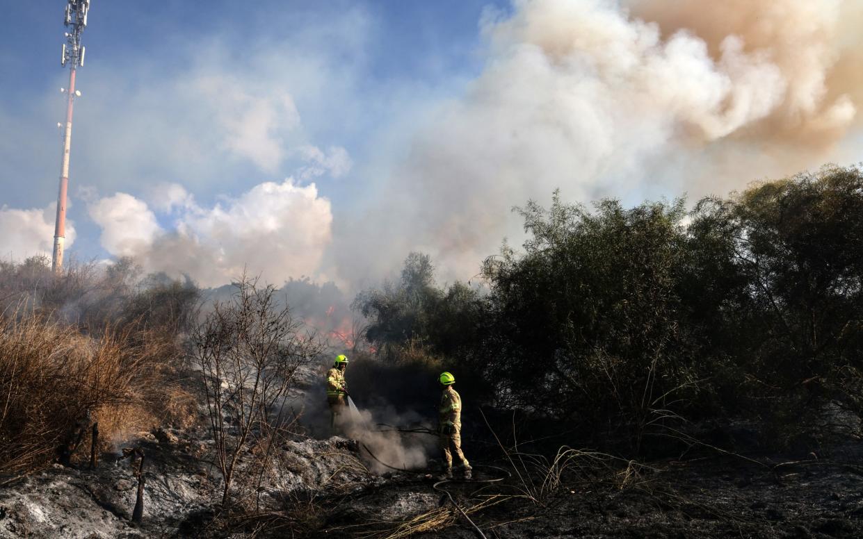 First responders put out a fire near Tel Aviv that was caused by a missile fired from Yemen