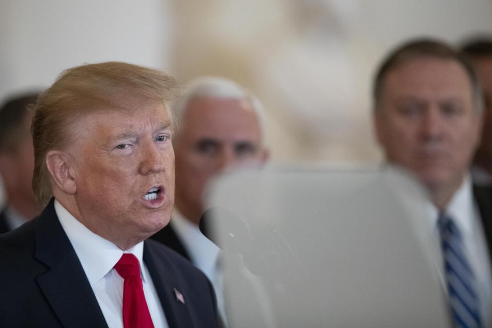 President Donald Trump addresses the nation from the White House on the ballistic missile strike that Iran launched against Iraqi air bases housing U.S. troops, Wednesday, Jan. 8, 2020, in Washington, accompanied by Vice President Mike Pence, Secretary of State Mike Pompeo and others. (AP Photo/Alex Brandon)