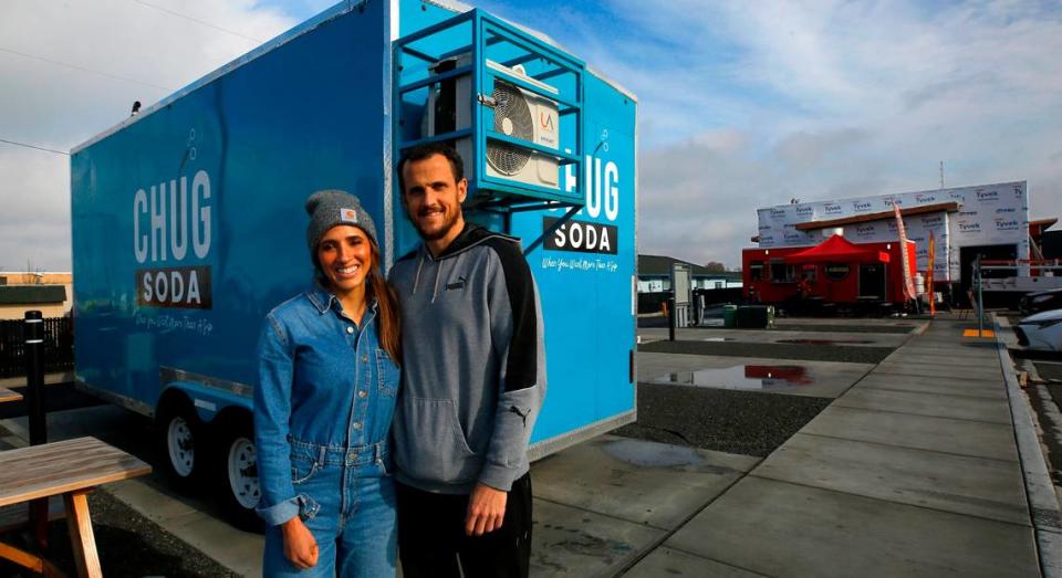 Rachel and Kevin Magelsen stand next to their food trailer called Chug Soda, while setting it up Wednesday in the Edison Street Food Park in Kennewick. They are the third mobile business to occupy a space at the venue on West Okanogan Avenue and North Edison Street. Bob Brawdy/bbrawdy@tricityherald.com