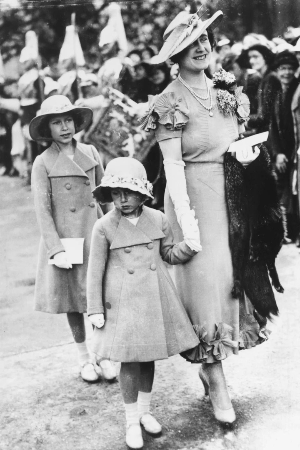 1936: The Queen Mother holding Princess Margaret's hand as Princess Elizabeth follows (Getty Images)