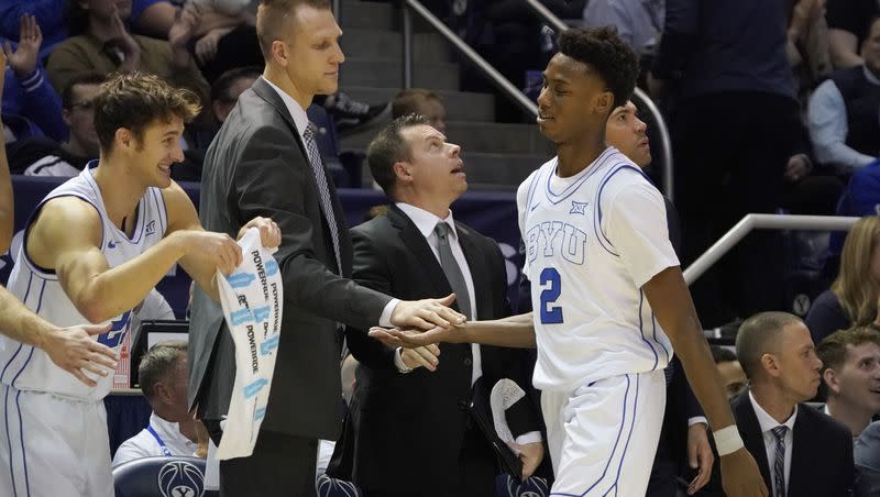 BYU guard Jaxson Robinson (2) is greeted by coaches and players after scoring a game-high 28 points during game against Denver, Wednesday, Dec. 13, 2023, in Provo, Utah. Robinson drained eight 3-pointers on the night.