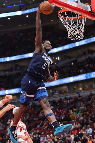 <p>Michael Reaves/Getty</p> Anthony Edwards dunks against the Chicago Bulls on Oct. 19, 2023 in Chicago