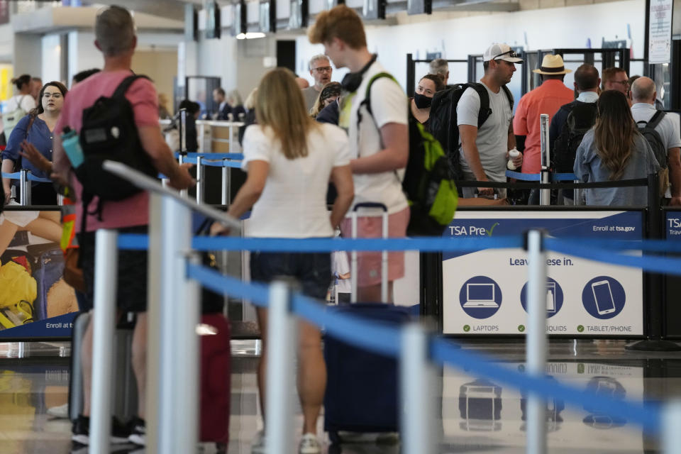 Travelers wait to go through security check point at O'Hare International Airport in Chicago, Thursday, Aug. 31, 2023. The Federal Aviation Administration predicts that this will be the third busiest holiday weekend of the year so far, behind only the Juneteenth weekend, which included Father's Day, and the Presidents Day break.(AP Photo/Nam Y. Huh)