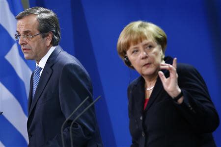 German Chancellor Angela Merkel and Greece's Prime Minister Antonis Samaras attend a news conference after talks at the Chancellery in Berlin, November 22, 2013. REUTERS/Thomas Peter