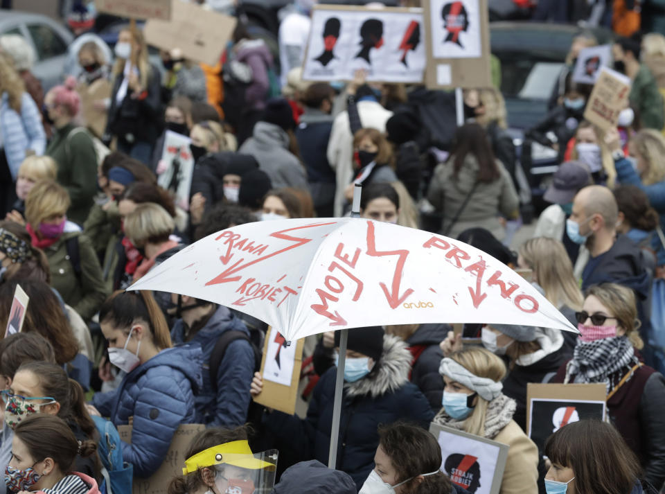 Women's rights activists with posters of the Women's Strike action protest in Warsaw, Poland, Wednesday, Oct. 28, 2020 against recent tightening of Poland's restrictive abortion law. Massive nationwide protests have been held ever since a top court ruled Thursday that abortions due to fetal congenital defects are unconstitutional. (AP Photo/Czarek Sokolowski)