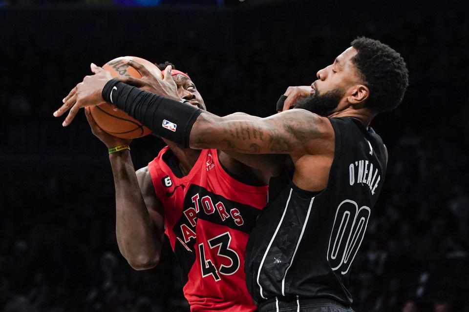 Toronto Raptors forward Pascal Siakam (43) tries to keep the ball from Brooklyn Nets forward Royce O'Neale (00) during the first half of an NBA basketball game Friday, Dec. 2, 2022, in New York. (AP Photo/Eduardo Munoz Alvarez)