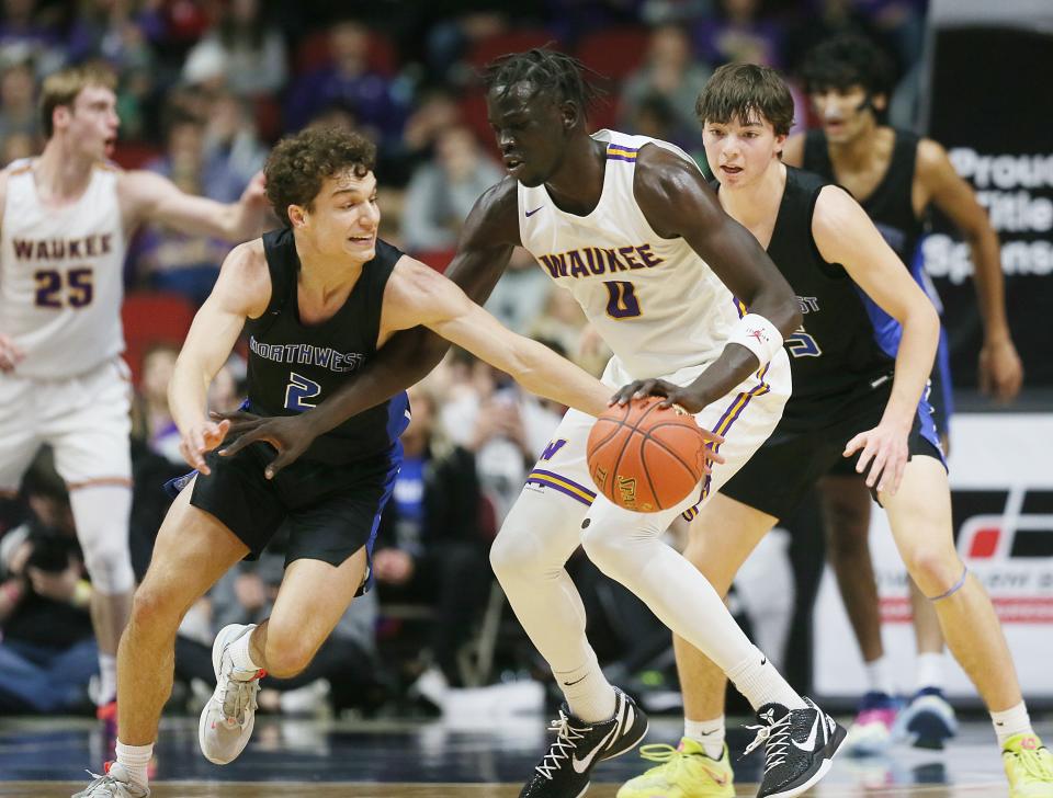 Waukee Northwest guard Cade Kelderman (2) steals the ball from Waukee forward Omaha Biliew (0) during the second quarter in the class 4A boys state basketball semifinal at Wells Fargo Arena Thursday.