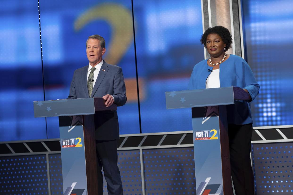 Republican Georgia Gov. Brian Kemp, left, and Democratic challenger Stacey Abrams face off in a televised debate, in Atlanta, Sunday, Oct. 30, 2022. (AP Photo/Ben Gray)