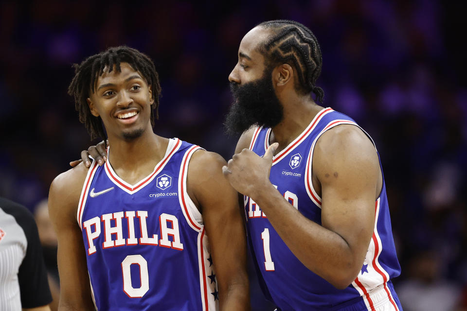 Philadelphia 76ers teammates Tyrese Maxey and James Harden talk during Game 1 of their first-round NBA playoffs series against the Toronto Raptors at Wells Fargo Center in Philadelphia on April 16, 2022. (Tim Nwachukwu/Getty Images)