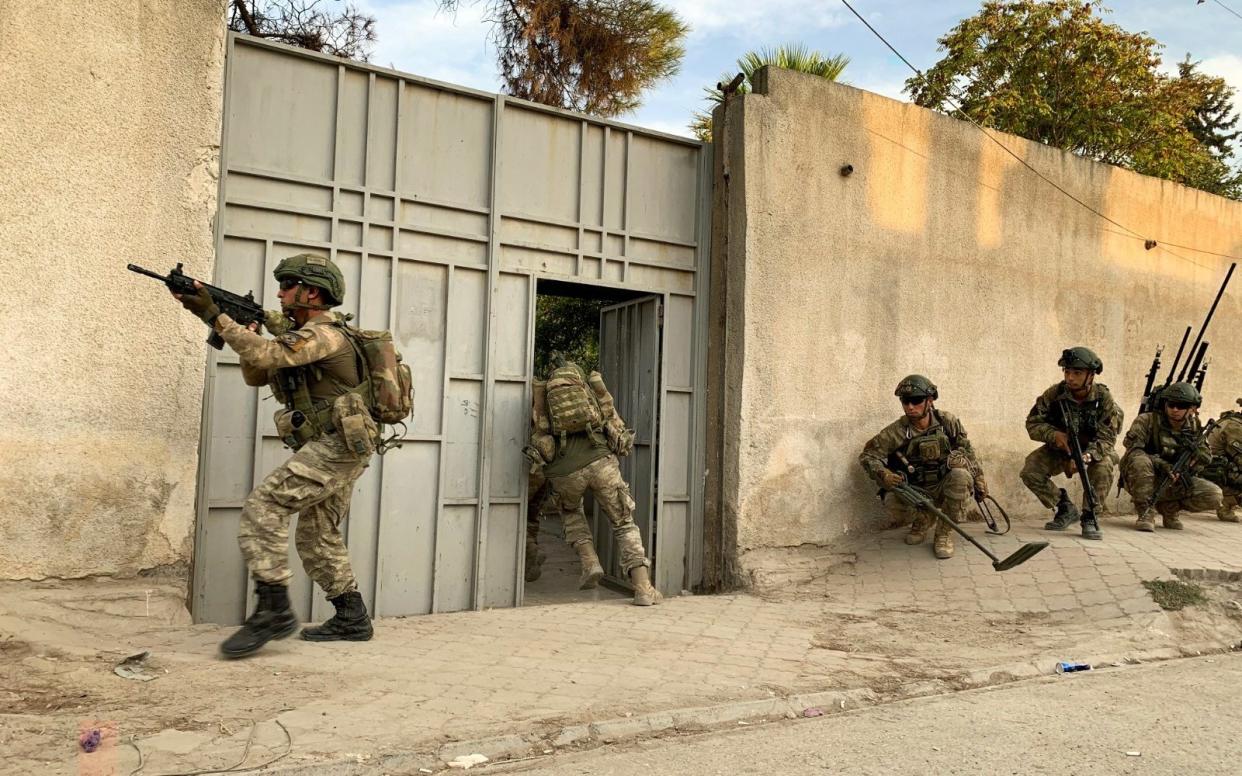 Turkish soldiers are seen in the border town of Tal Abyad, Syria - via REUTERS