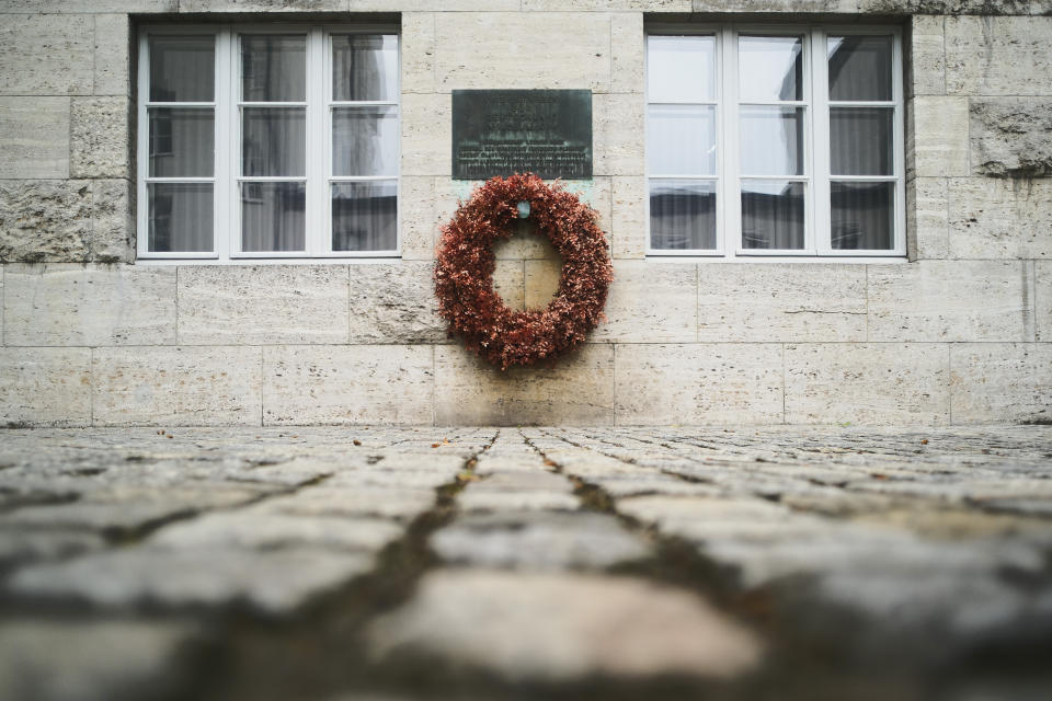 In this Friday, July 12, 2019 photo a wreath fixed under a remembrance plaque marking the place where several leaders of the failed assassinate to Adolf Hitler on July 20, 1944 was shoot dead, in the courtyard of the Bendlerblock building of the German defensive ministry, in Berlin. Germany is marking the 75th anniversary of the most famous plot to kill Adolf Hitler. (AP Photo/Markus Schreiber)