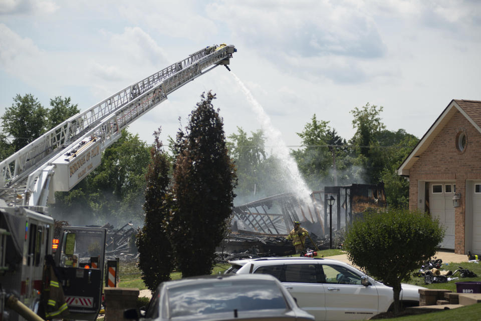 Police and emergency services control the smoldering debris of the three houses that exploded near Rustic Ridge Drive and Brookside Drive in Plum, Pa., on Saturday, Aug. 12, 2023. (Samuel Long/Pittsburgh Post-Gazette via AP/Pittsburgh Post-Gazette via AP)