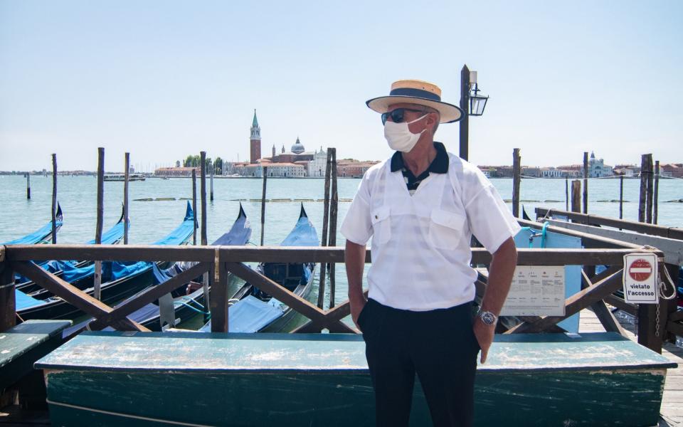 A gondolier waits for customers in Venice  - Getty
