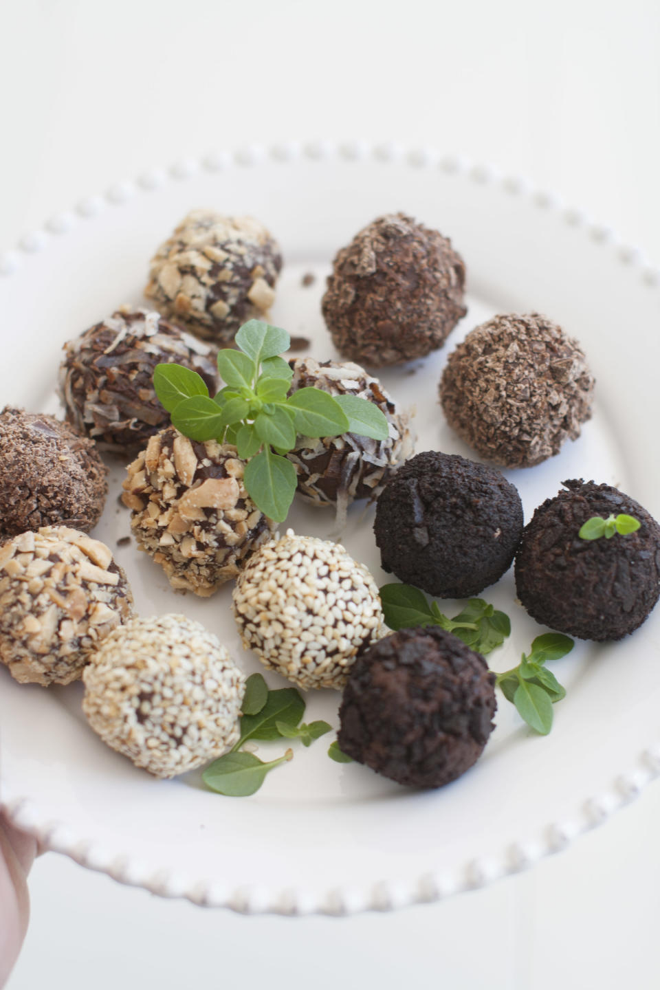 This March 24, 2014 photo shows a variety of basil tea truffles coated with toasted coconut, toasted sesame seeds, chopped marcona almonds and chocolate wafer cookies, in Concord, N.H. (AP Photo/Matthew Mead)