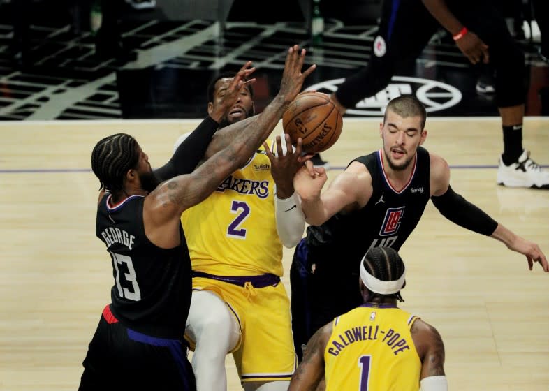 LOS ANGELES, CA - MAY 6, 2021: Los Angeles Lakers center Andre Drummond (2) can't grab a defensive rebound while being double teamed by LA Clippers guard Paul George (13) and LA Clippers center Ivica Zubac (40) in the first half at Staples Center on May 6, 2021 in Los Angeles, California.(Gina Ferazzi / Los Angeles Times)