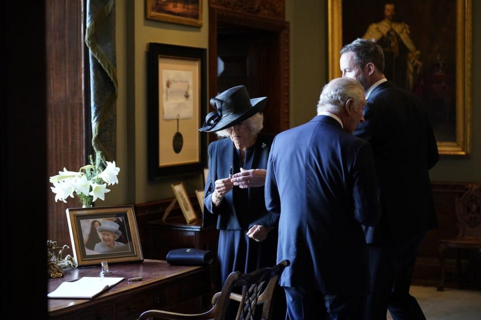 The Queen Consort deals with the leaky pen (Niall Carson/PA) (PA Wire)