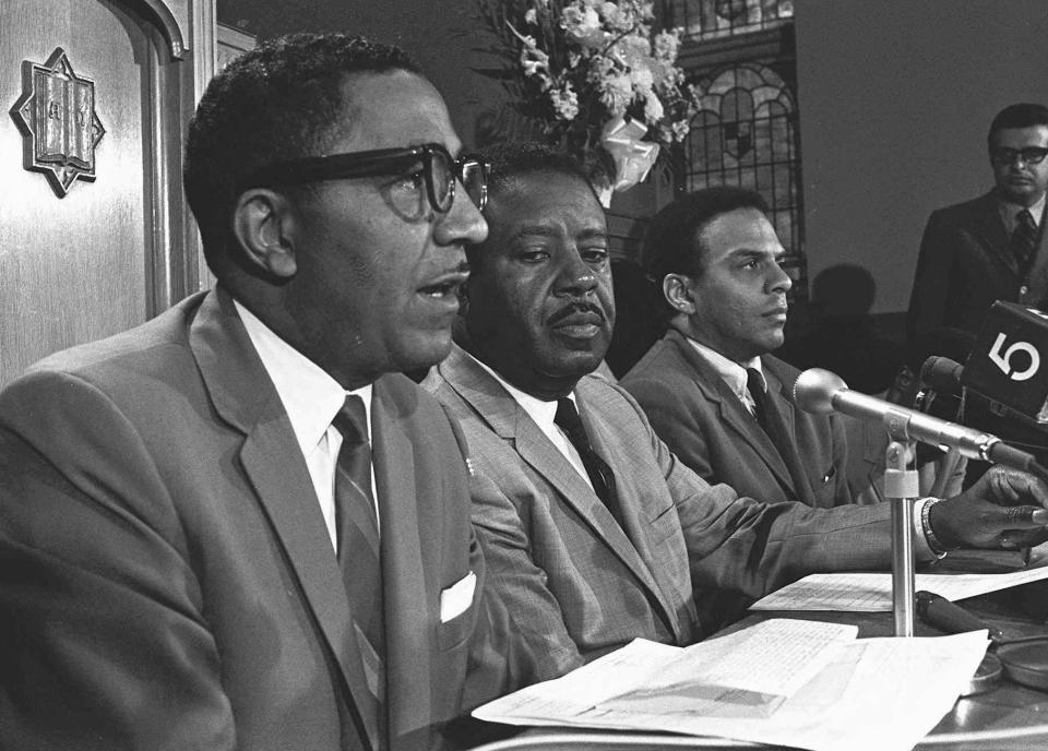 FILE - In this April 1968 file photo, the Rev. Ralph D. Abernathy, center, talks with aides, the Rev. Joseph E. Lowery, left, and the Rev. Andrew Young, during an Atlanta news conference. Lowery, a veteran civil rights leader who helped the Rev. Martin Luther King Jr. found the Southern Christian Leadership Conference and fought against racial discrimination, died Friday, March 27, 2020, a family statement said. He was 98. (AP Photo, File))