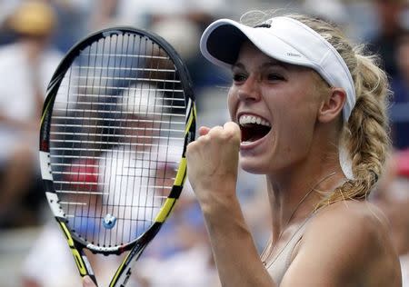 Caroline Wozniacki of Denmark celebrates her win over Maria Sharpova of Russia at the 2014 U.S. Open tennis tournament in New York, August 31, 2014. REUTERS/Ray Stubblebine