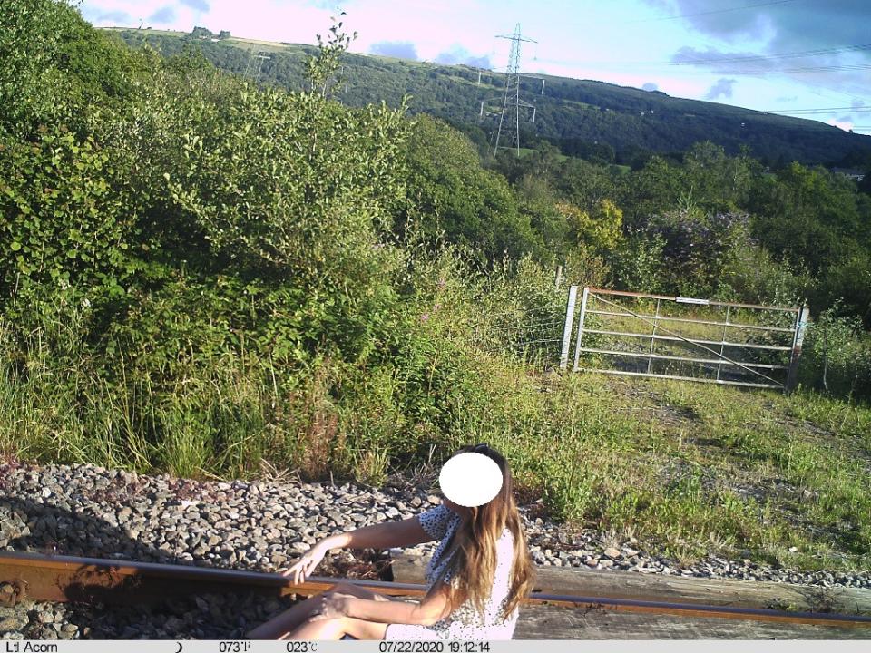 Woman poses on railway