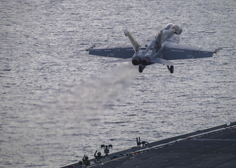 In this photograph released by the U.S. Navy, an F/A-18 Super Hornet launches off the flight deck of the Nimitz-class aircraft carrier USS Theodore Roosevelt on July 5, 2024, in the South China Sea. The Roosevelt is replacing the USS Dwight D. Eisenhower in the Navy's campaign against attacks by Yemen's Houthi rebels targeting shipping in the Red Sea corridor over the Israel-Hamas war in the Gaza Strip. (Seaman Aaron Haro Gonzalez/U.S. Navy, via AP)