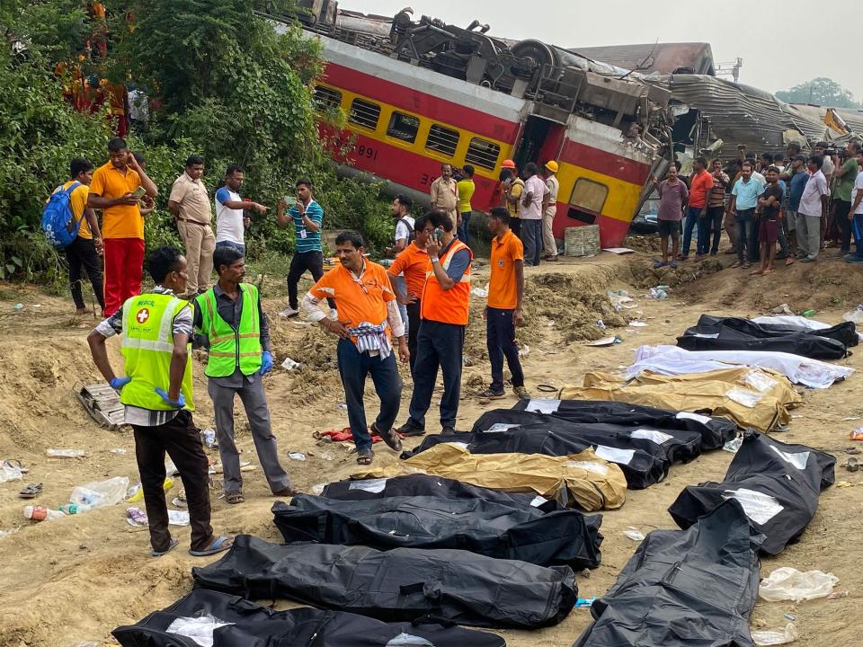 Medical workers stand in front of the bodies of victims killed in an accident after a three-train collision near Balasore, about 200 km (125 miles) from the state capital Bhubaneswar, on June 3, 2023.