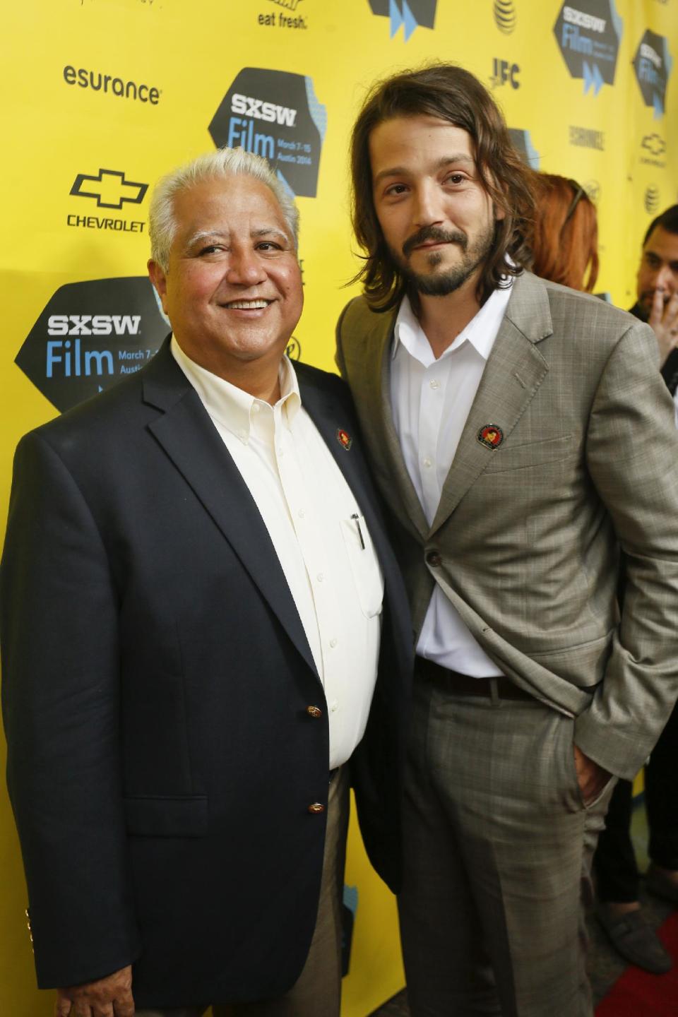 FILE - In this Monday, March 10, 2014 file photo, Director Diego Luna, right, and Paul F. Chavez arrive at the North American premiere of "Cesar Chavez" during the SXSW Film Festival, in Austin, Texas. For Chavez, one of Cesar Chavez’s eight children and head of the Cesar Chavez Foundation, the screening for farm workers in Delano, Calif., was the most significant. “To come back where the work began, where so much history happened, then to be with people that work on a daily basis to put food on our table, it’s heartwarming," he said. (Photo by Jack Plunkett/Invision/AP, file)