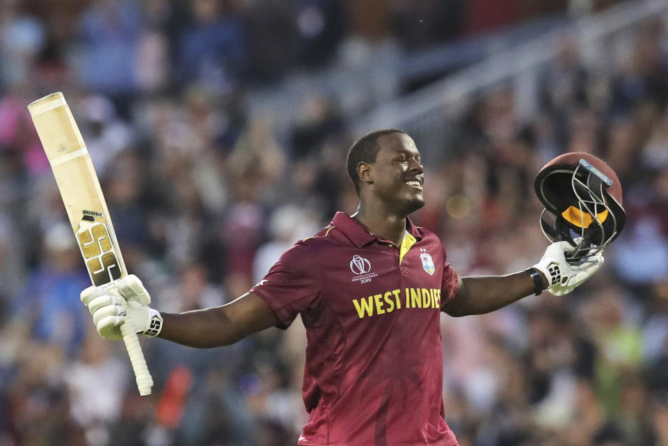 West Indies' Carlos Brathwaite celebrates after scoring a century during the Cricket World Cup match between New Zealand and West Indies at Old Trafford in Manchester, England, Saturday, June 22, 2019. (AP Photo/Jon Super)