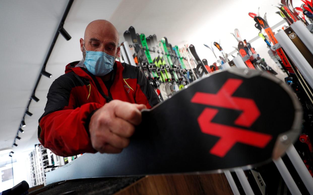 Giordano Callegari, 59, does maintenance work on a pair of skis at his ski rental at the ski resort of Passo Tonale - REUTERS