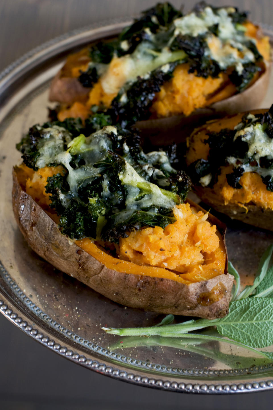 In this image taken on Dec. 3, 2012, loaded sweet potatoes with roasted garlic are shown served on a plate in Concord, N.H. (AP Photo/Matthew Mead)