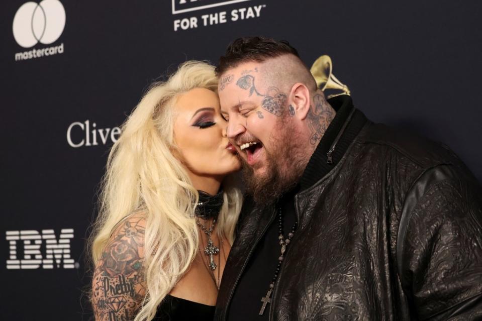 Bunnie Xo plants a kiss on hubby Jelly Roll at the 2024 pre-Grammys gala in Beverly Hills, California. REUTERS