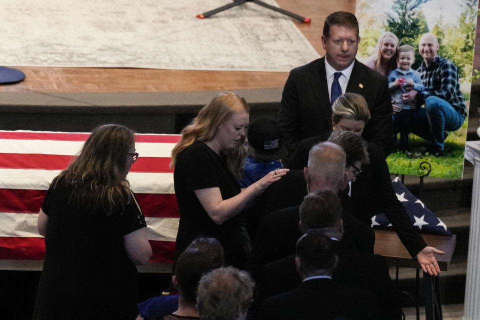 Family and friends are seated during a memorial service for Officer Joshua Eyer, Friday, May 3, 2024, in Charlotte, N.C. Police in North Carolina say a shootout that killed Eyer and wounded and killed other officers began as officers approached a home to serve a felony warrant on Monday. (AP Photo/Chris Carlson)