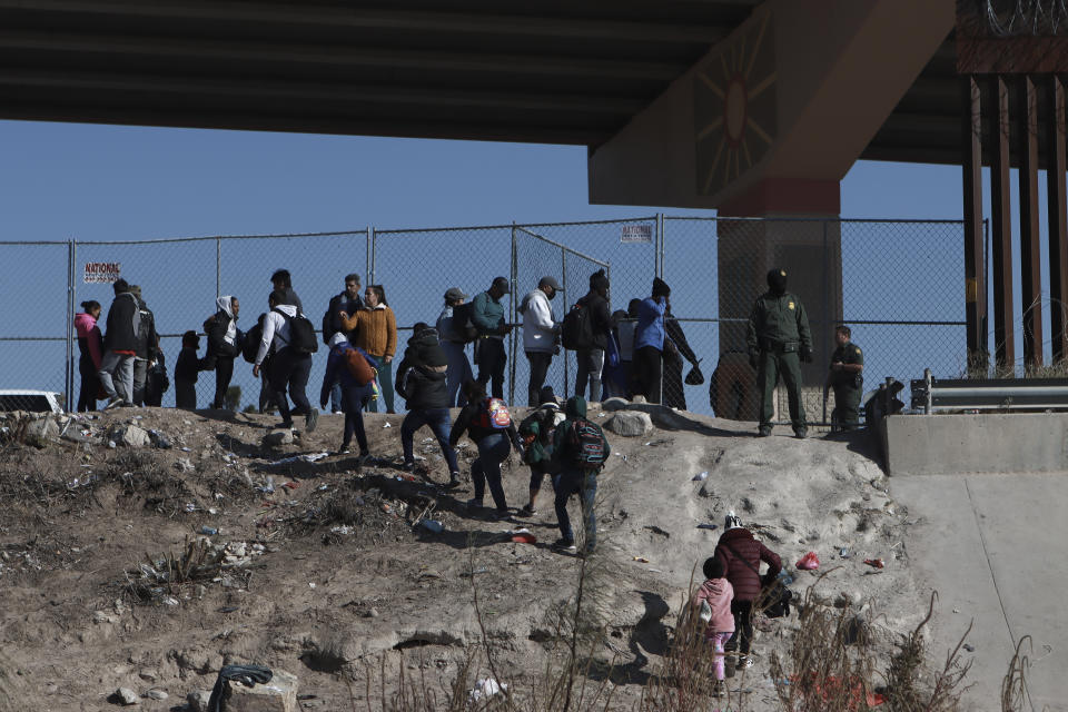 Migrants cross the U.S.-Mexico border from Ciudad Juarez, Mexico, and turn themselves into U.S. Border Patrol agents, Monday, Dec. 19, 2022. Pandemic-era immigration restrictions in the U.S. known as Title 42 are set to expire on Dec. 21. (AP Photo/Christian Chavez)