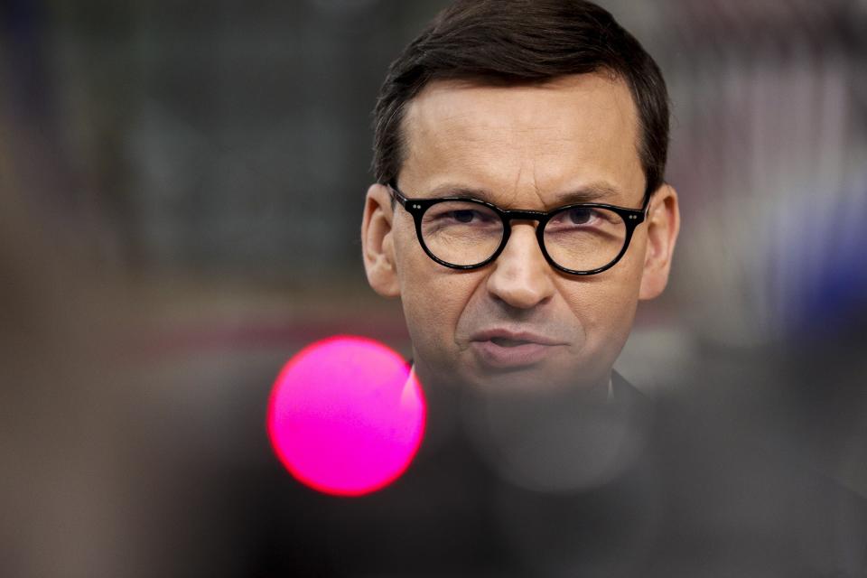 Poland's Prime Minister Mateusz Morawiecki talks to journalists as he arrives for an EU summit in Brussels, Thursday, Oct. 21, 2021. European Union leaders head into a standoff between Poland and most of the other EU member nations over the rule of law in the eastern member state. Other issues for the 27 EU leaders include climate change, the energy crisis, COVID-19 developments and migration. (Olivier Hoslet, Pool Photo via AP)