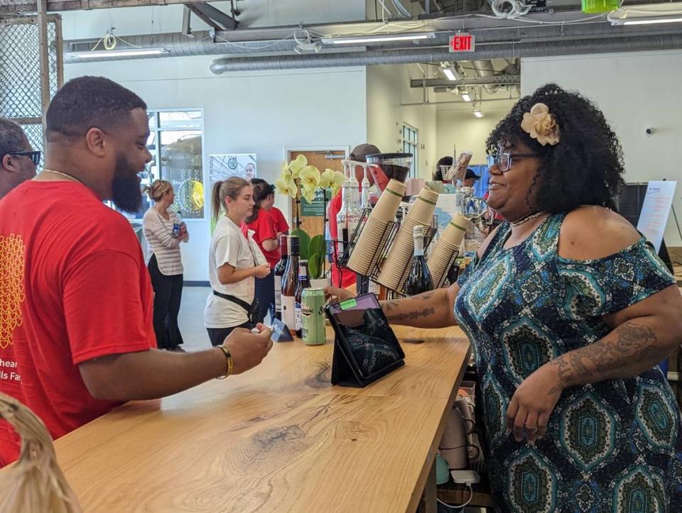 Monique Mims, the first trained barista at Change Please Coffee in Charlotte, talks with a customer at the Innovation Barn cafe at 932 Siegle Ave.