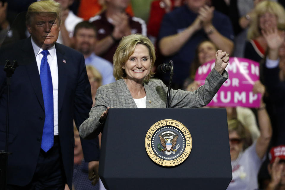 Sen. Cindy Hyde-Smith, R-Miss., urges the audience to cheer for Republican President Donald Trump after he introduced her at a rally Tuesday, Oct. 2, 2018, in Southaven, Miss. Hyde-Smith is running for the final two years of the term of former Republican Sen. Thad Cochran, who retired last year. (AP Photo/Rogelio V. Solis)