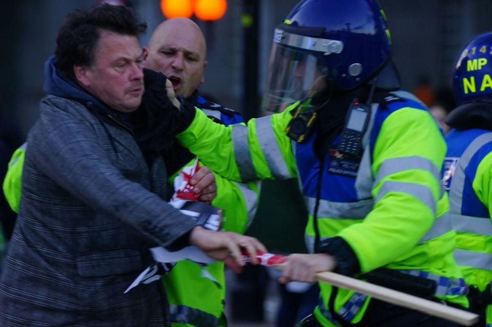 A counter-protester is detained by police in Parliament Square (PA)