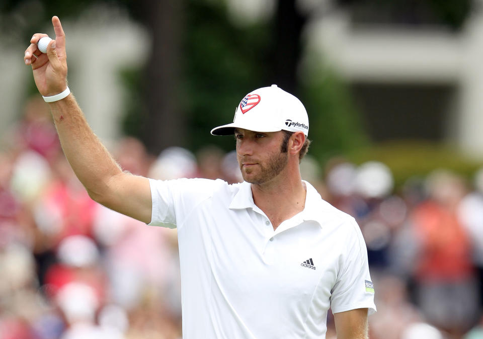 MEMPHIS, TN - JUNE 10: Dustin Johnson waves to the crowd after finishing on the 18th hole during the final round the FedEx St. Jude Classic at TPC Southwind on June 10, 2012 in Memphis, Tennessee. He won the tournament at 9 under par. (Photo by Andy Lyons/Getty Images)