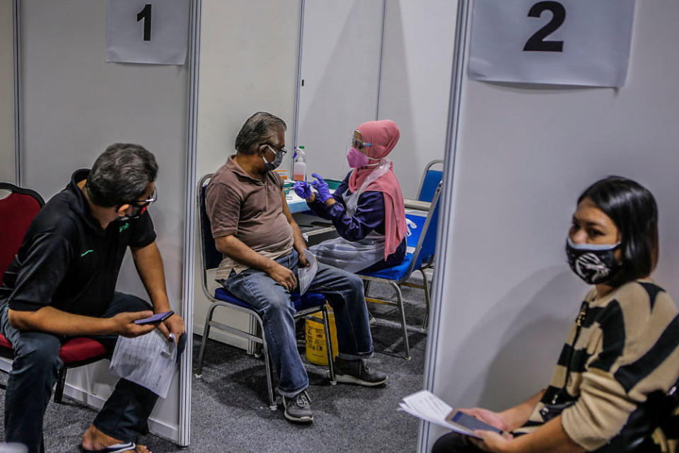 Walk-in vaccine recipients receive their Covid-19 jabs at the Kuala Lumpur Convention Centre vaccination centre, August 2, 2021. ― Picture by Hari Anggara