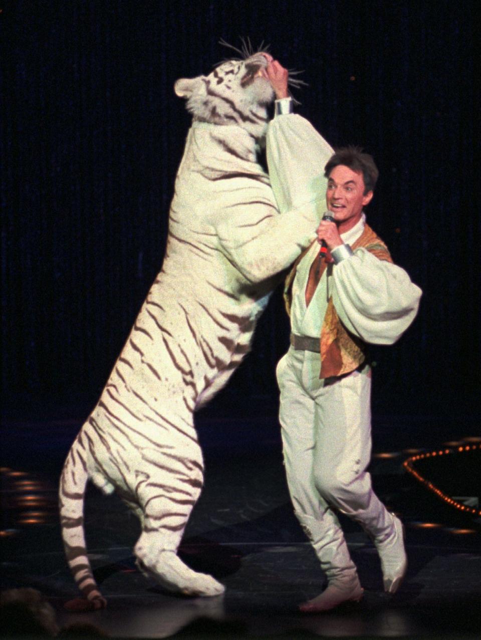 Roy, of the world-renowned illusionists Siegfried & Roy, performs with a white tiger during their 15,000th live show Thursday night, Jan. 18, 1996, at The Mirage in Las Vegas.