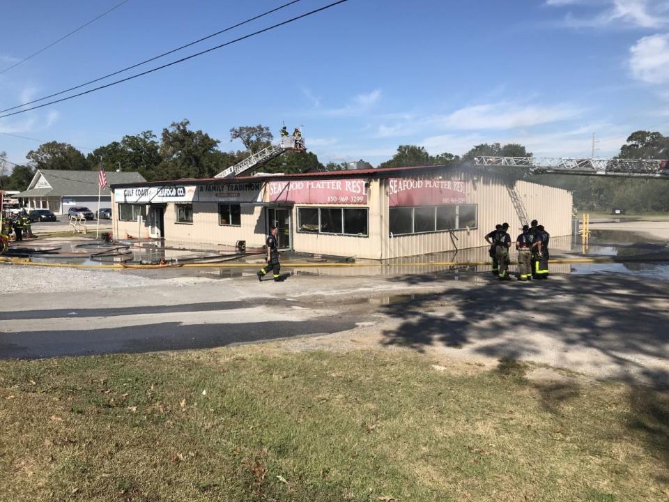 Firefighters respond to a blaze at Gulf Coast Seafood Market at 2250 W. Nine Mile Road in Pensacola on Oct. 31, 2022.