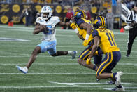 North Carolina quarterback Conner Harrell runs against West Virginia during the first half of an NCAA college football game at the Duke's Mayo Bowl Wednesday, Dec. 27, 2023, in Charlotte, N.C. (AP Photo/Chris Carlson)