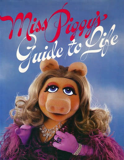 “Miss Piggy's Guide to Life" is a nationally bestselling advice book written by Miss Piggy in 1981 covering topics like fashion, beauty, romance, finance, travel, diet, entertaining, and etiquette.