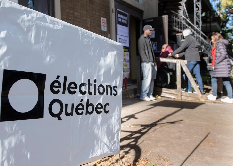 People wait in line to vote on Quebec election day in Montreal on Oct. 3.