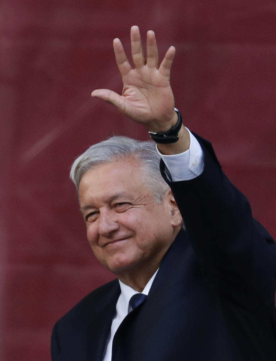 Mexico's President Andres Manuel Lopez Obrador greets the crowd at a rally to celebrate the one-year anniversary of his election, in Mexico City's main square, the Zocalo, Monday, July 1, 2019. (AP Photo/Marco Ugarte)