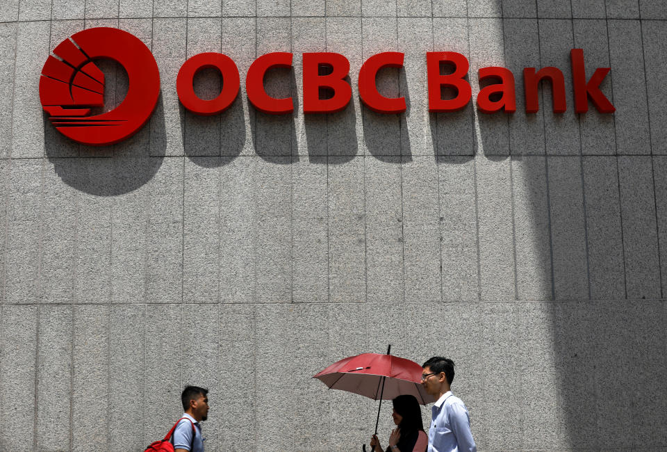 People pass an OCBC Bank office in Singapore April 18, 2017. REUTERS/Edgar Su