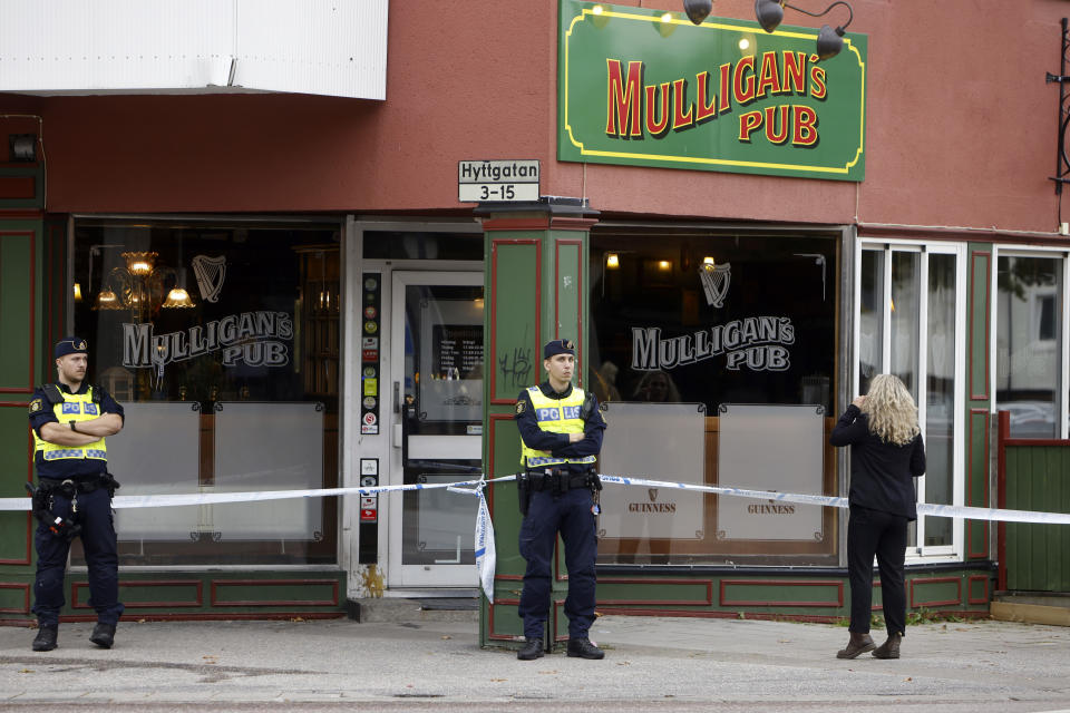 Police stand outside a pub where two people were killed and two wounded following a shooting, in Sandviken, some 162 kilometers (100 miles) northwest of Stockholm, Friday, Sept. 22, 2023. In a statement, police said that a man in his 20s and another in his 70s died Friday of injuries sustained in the shooting late Thursday at the pub in Sandviken. (Henrik Hansson/TT News Agency via AP)